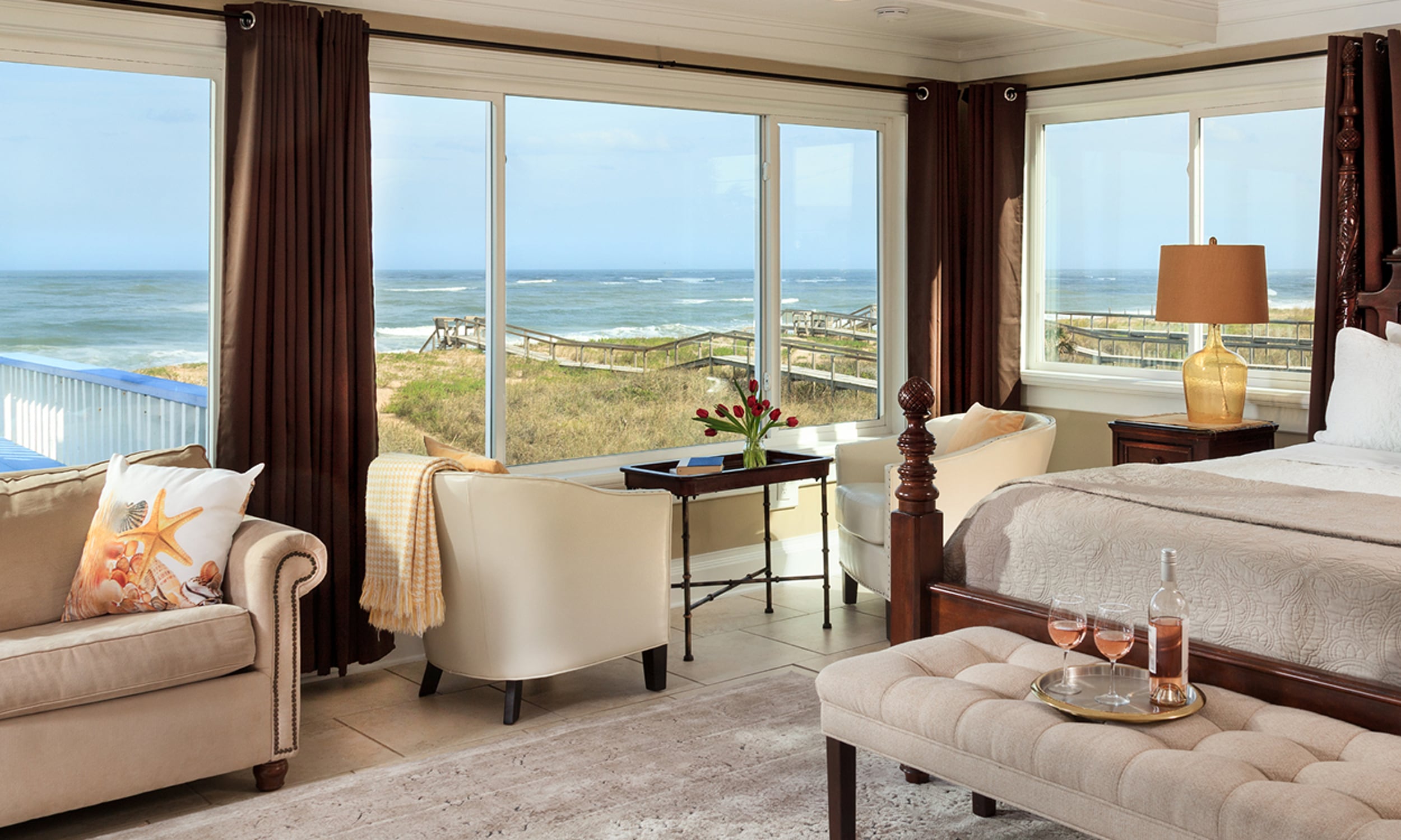 Ocean view room at Beachcomber Cottages on Vilano featuring elegant furniture and a champagne tray