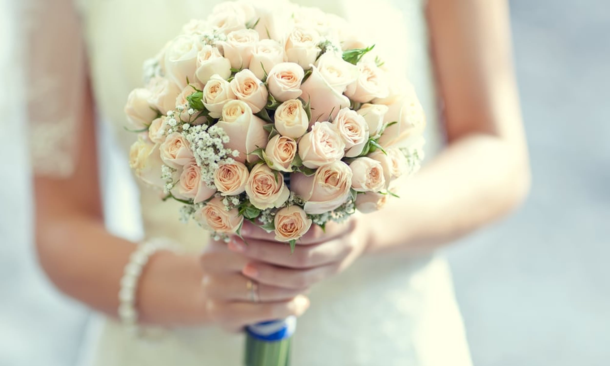 Bride holding a fresh-cut rose bouquet 