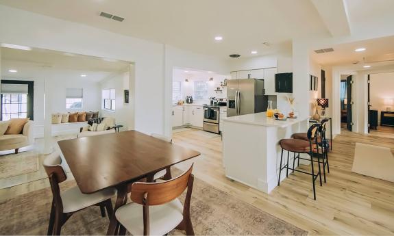 An open kitchen and dining area with a sunken living room beyond