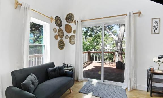 The treehouse property with sofa and a view of the deck