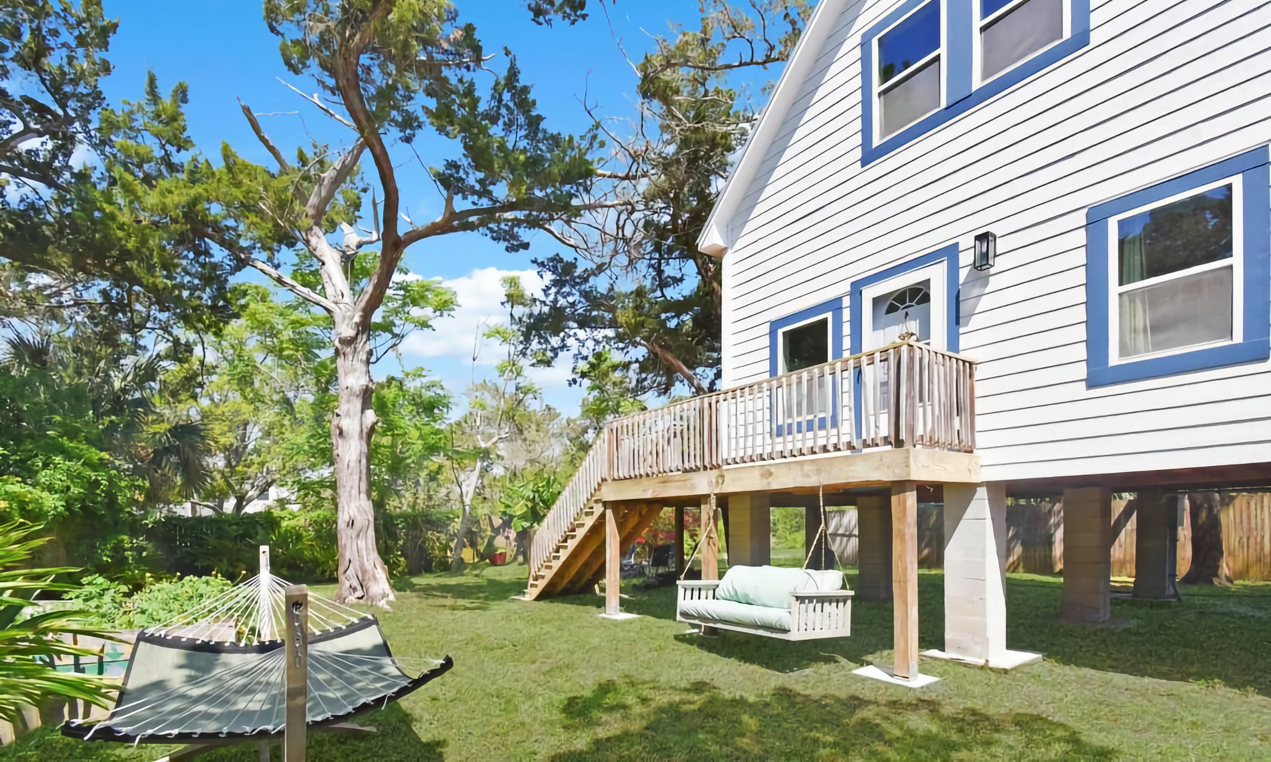 The tree house property with deck and hammock and porch swing