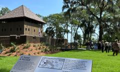 Fort Mose viewed beyond a sign describing the location