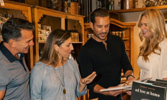 Four people looking at items in a gift shop