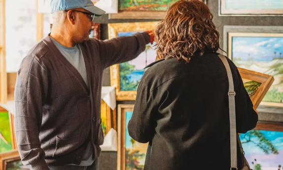 Man and woman admiring artwork at the Hastings Fall Art Festival