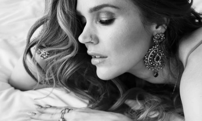 Joss Stone poses in a black-and-white photograph.