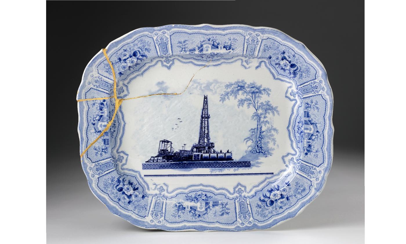 A blue transferware platter, cracked, and titled "Fracked"
