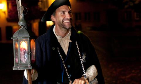 A night watchman with a lantern