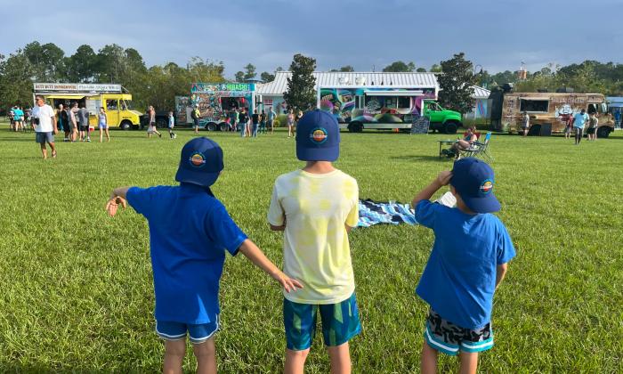 Boys wearing Visit St. Augustine hats at the Nocatee Food Truck Friday event