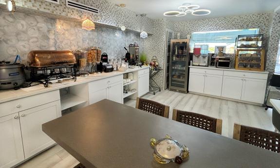 The breakfast area at Ocean Sands has table for seating and buffet counters 