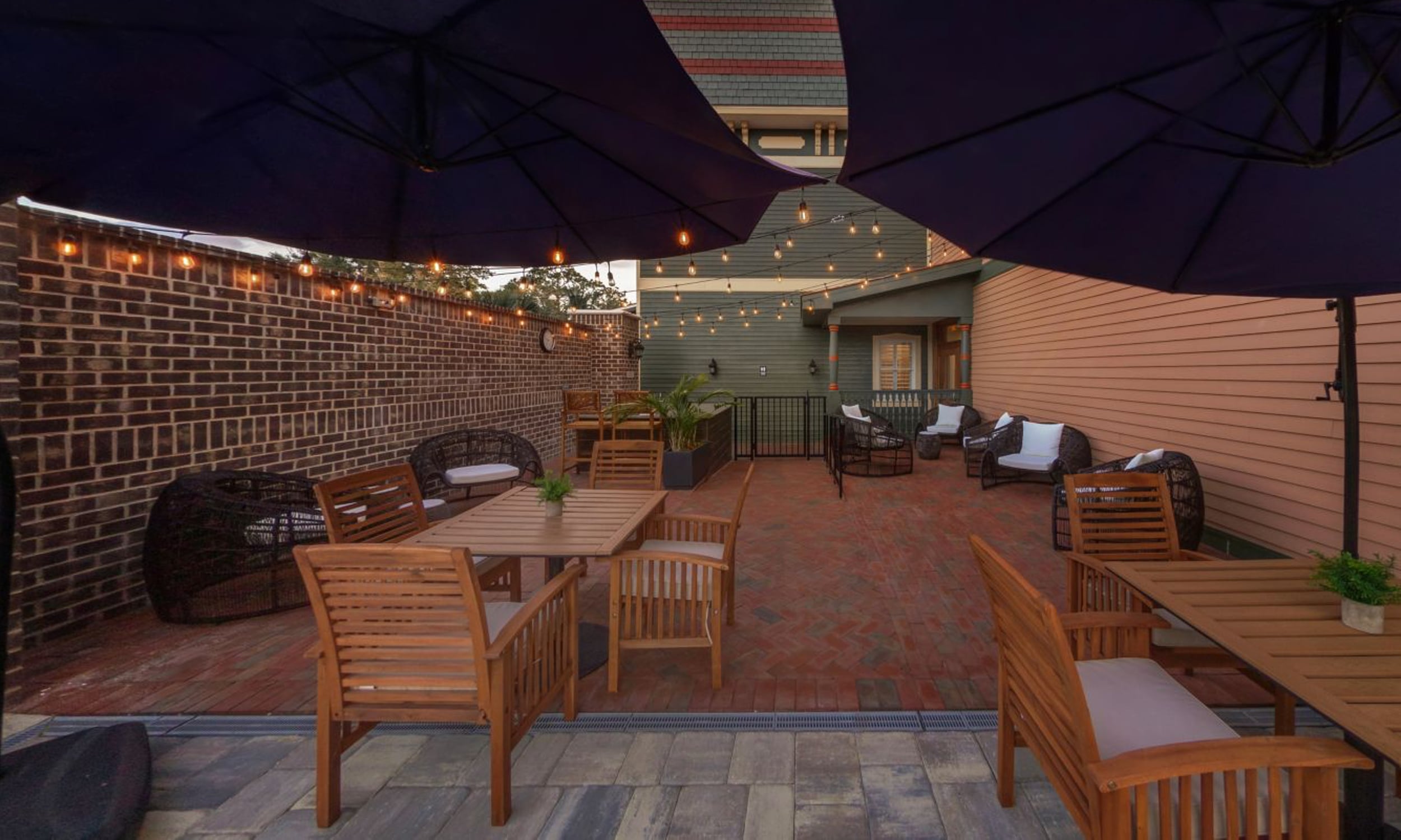 The patio at Renaissance Hotel in Historic Downtown featuring string lights, tables, umbrellas, and lounge chairs