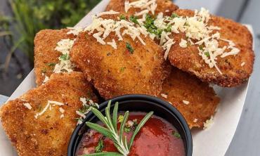 Fried ravioli bites served with marinara sauce on the side