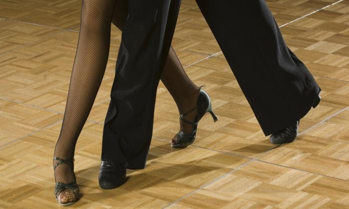 Two pairs of feet dancing the rumba