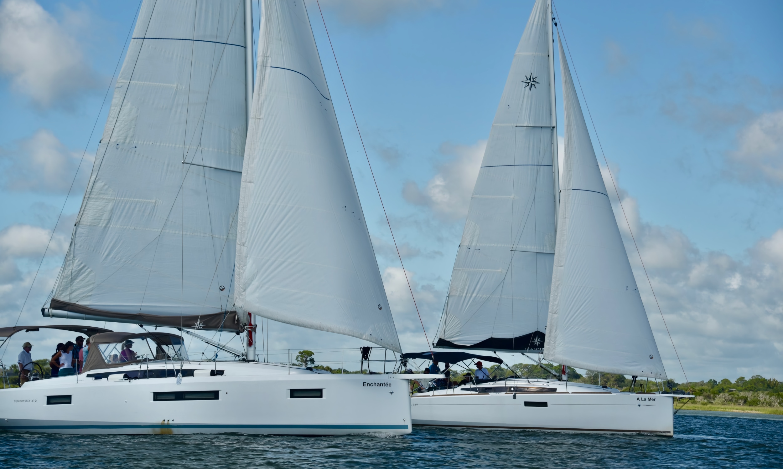 Two sailboats moving through the water