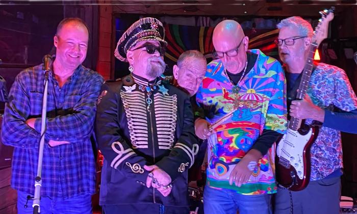 The Statz Band, with the frontman in his ringleader garb