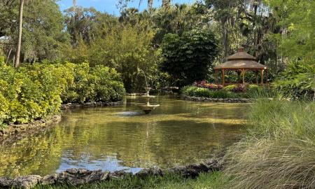 A water fountain and gazebo in the garden area